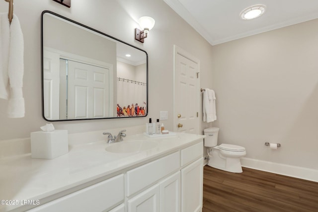 bathroom with ornamental molding, wood-type flooring, toilet, and vanity