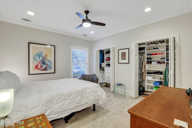 bedroom featuring ceiling fan, ornamental molding, and light colored carpet