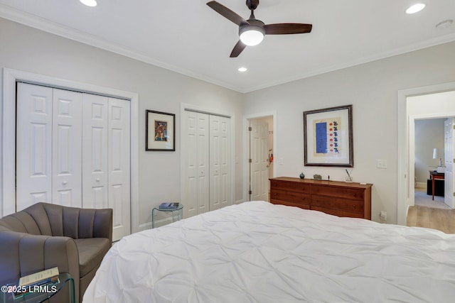 bedroom with multiple closets, crown molding, and ceiling fan