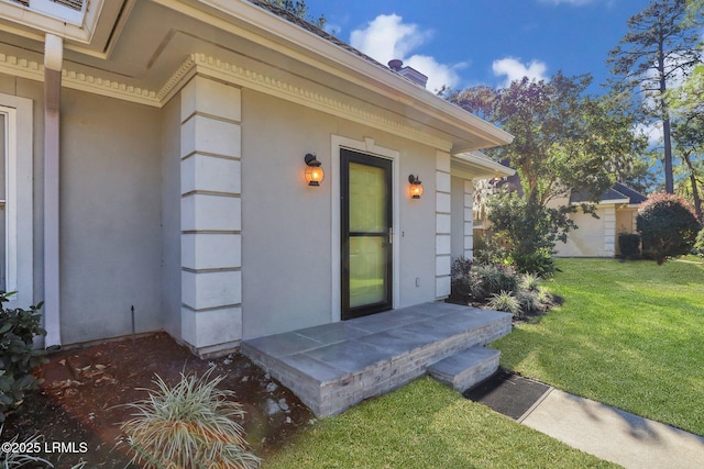 doorway to property featuring a lawn