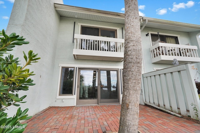 back of property featuring a patio and stucco siding