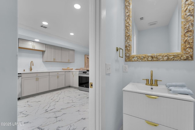 interior space featuring visible vents, a sink, marble finish floor, two vanities, and recessed lighting