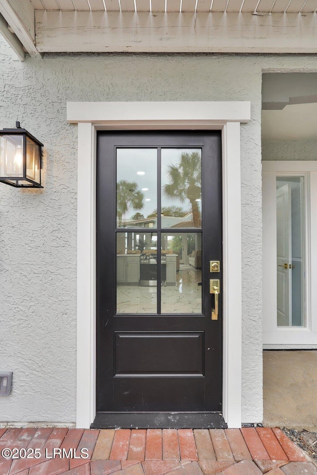 doorway to property with stucco siding