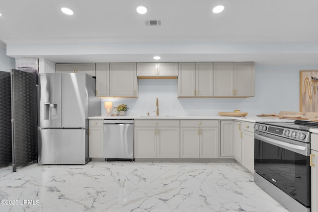 kitchen featuring visible vents, stainless steel appliances, light countertops, a sink, and recessed lighting