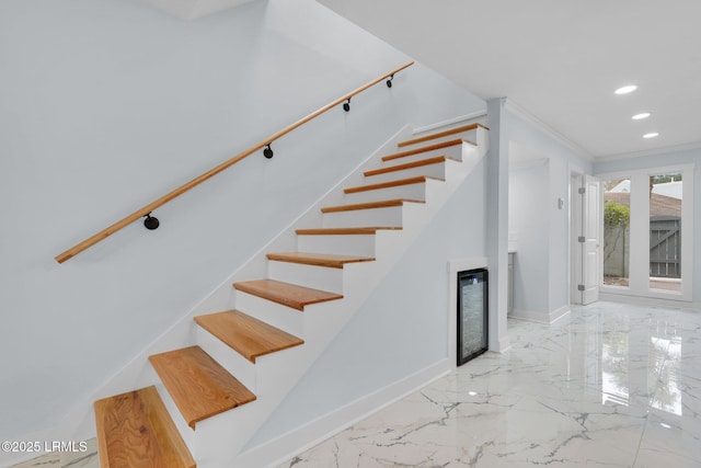 stairs with marble finish floor, baseboards, crown molding, and recessed lighting