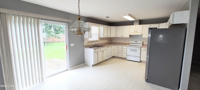 15 Grackle Ln, Beaufort, SC 29906 - kitchen with white appliances, a chandelier, under cabinet range hood, hanging light fixtures, and light flooring