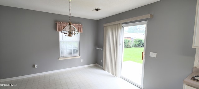 15 Grackle Ln, Beaufort, SC 29906 - unfurnished dining area featuring a chandelier and baseboards