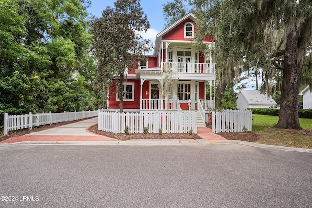 view of front facade with a balcony and covered porch