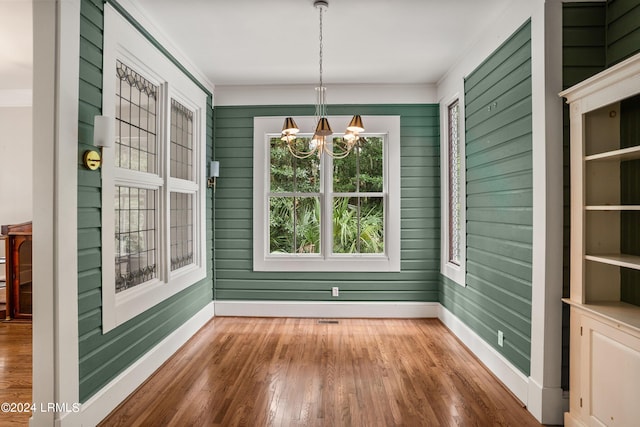 unfurnished sunroom featuring a notable chandelier