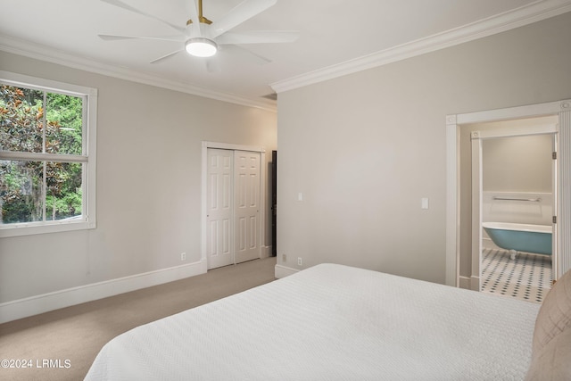 bedroom featuring crown molding, light colored carpet, ceiling fan, and a closet