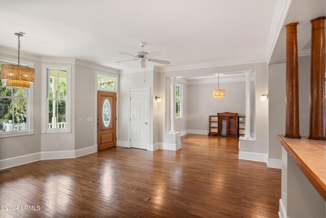 entryway featuring crown molding, ceiling fan, dark hardwood / wood-style floors, and decorative columns