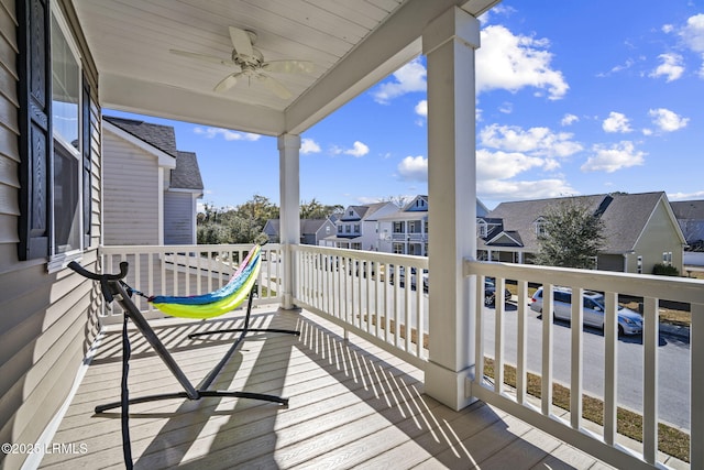 balcony featuring a residential view and a ceiling fan