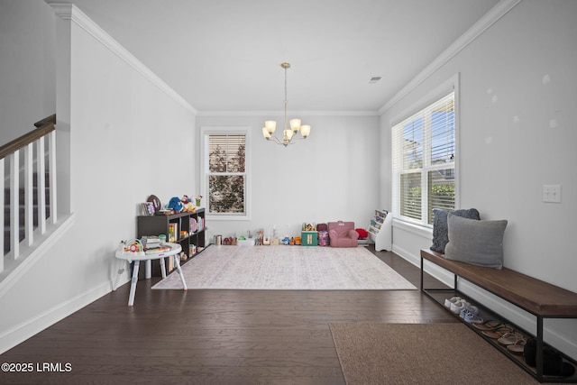 game room featuring baseboards, visible vents, wood finished floors, crown molding, and a chandelier