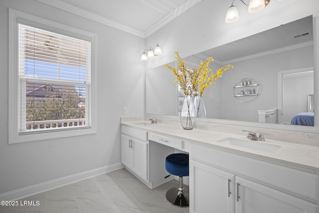 bathroom with ornamental molding, visible vents, a sink, and baseboards