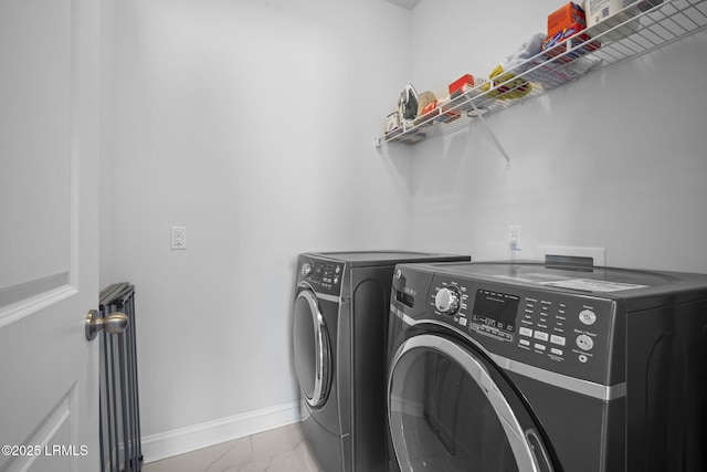 washroom with washer and dryer, laundry area, marble finish floor, and baseboards