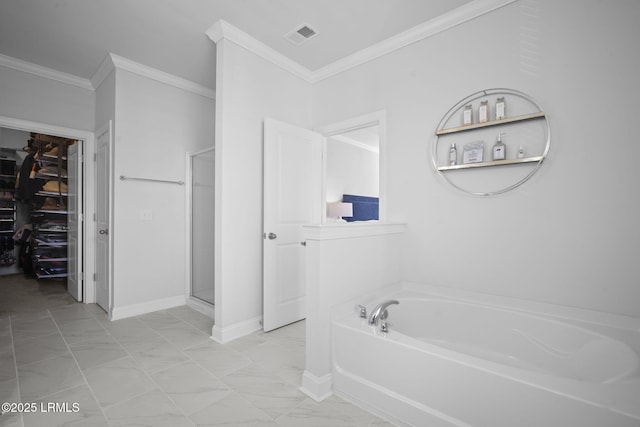 bathroom featuring a stall shower, ornamental molding, marble finish floor, a garden tub, and a spacious closet