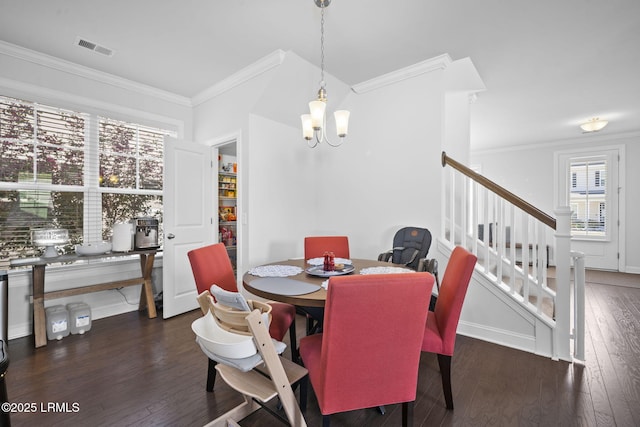 dining area featuring visible vents, crown molding, stairway, and hardwood / wood-style floors