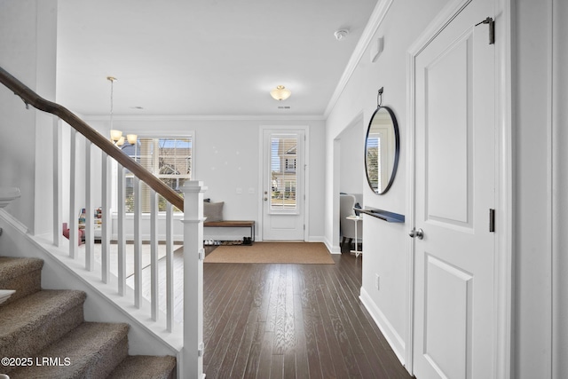 entryway featuring a notable chandelier, dark wood-type flooring, baseboards, ornamental molding, and stairway