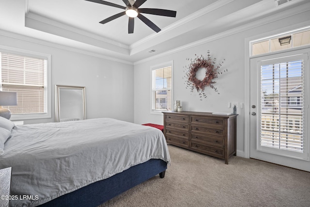 carpeted bedroom with access to outside, visible vents, a raised ceiling, and crown molding