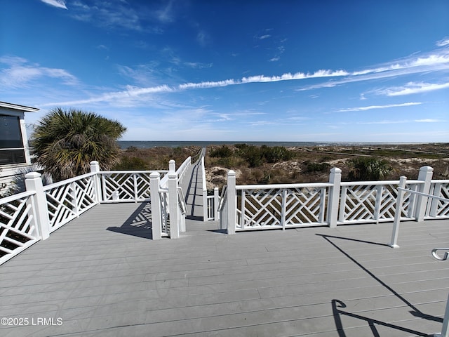 wooden terrace featuring a water view