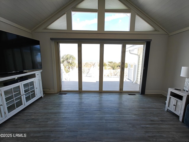 unfurnished living room with plenty of natural light, lofted ceiling, and dark wood finished floors