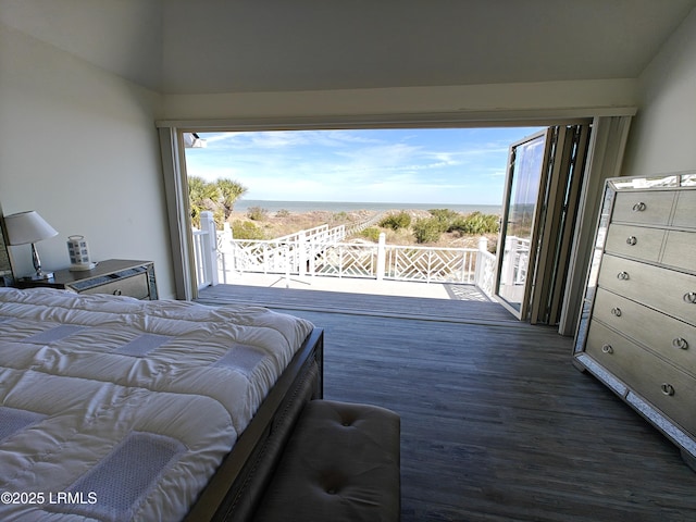 bedroom featuring access to outside, dark wood-type flooring, and a water view