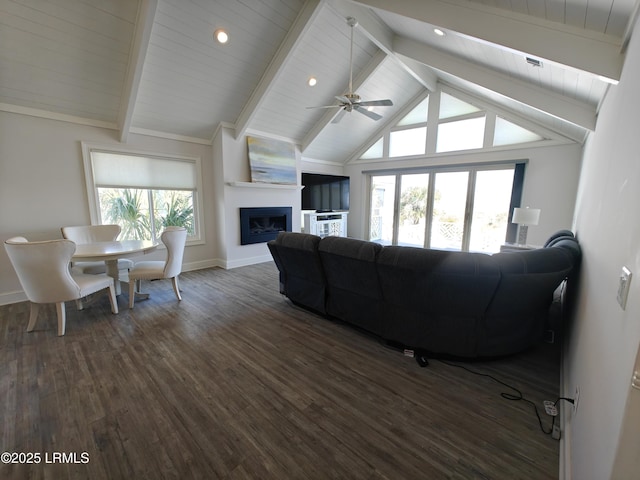 living room featuring dark wood finished floors, a fireplace, vaulted ceiling with beams, ceiling fan, and baseboards