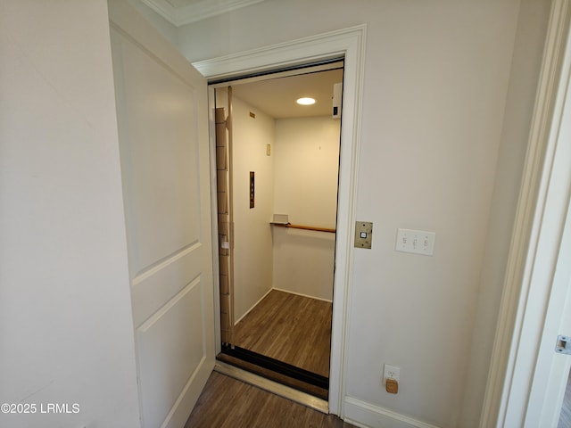 hallway featuring dark wood-style flooring and elevator