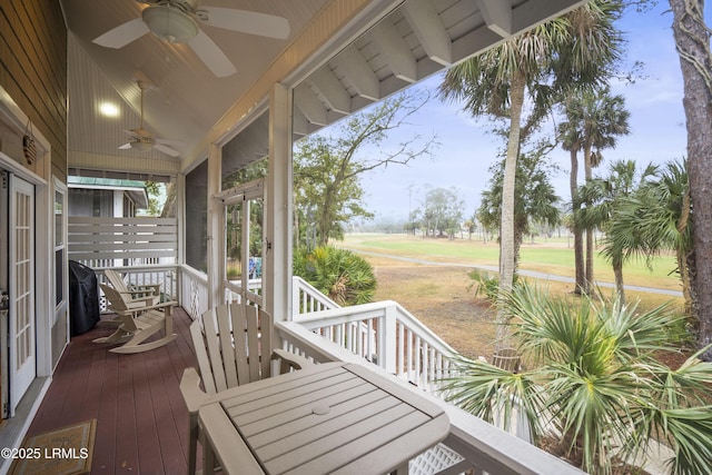 wooden terrace featuring ceiling fan and outdoor dining area