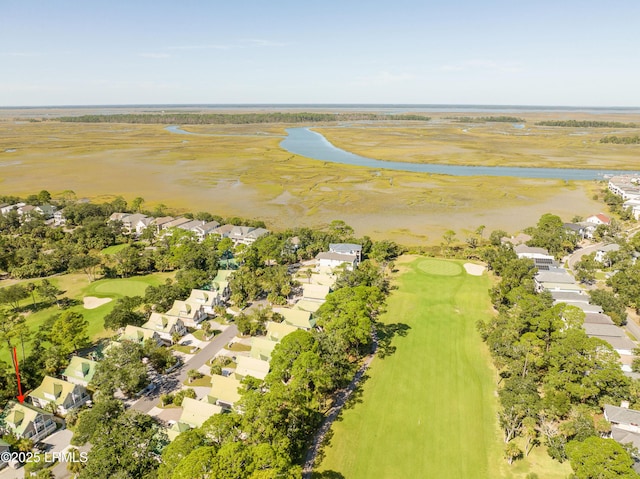 drone / aerial view with view of golf course, a water view, and a residential view