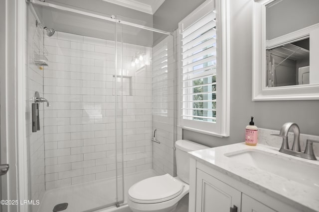 bathroom featuring toilet, a stall shower, crown molding, and vanity