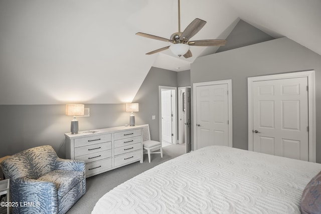 bedroom featuring vaulted ceiling, dark carpet, and a ceiling fan