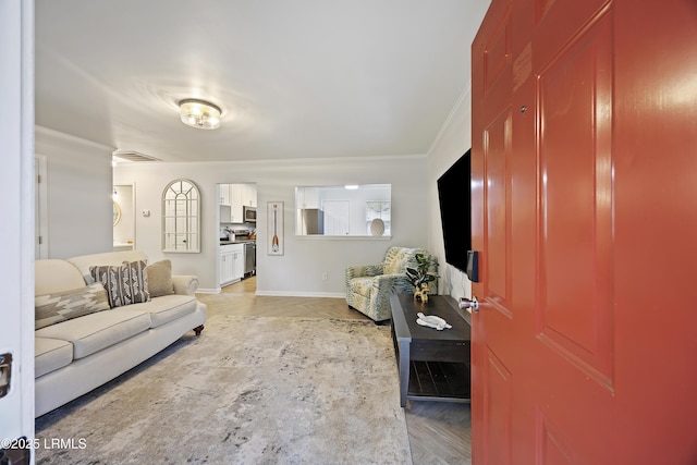 living room with crown molding and light wood-type flooring