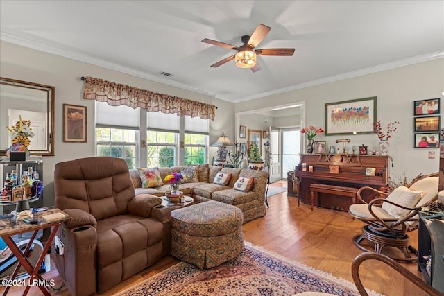 living room featuring ceiling fan, ornamental molding, and wood-type flooring