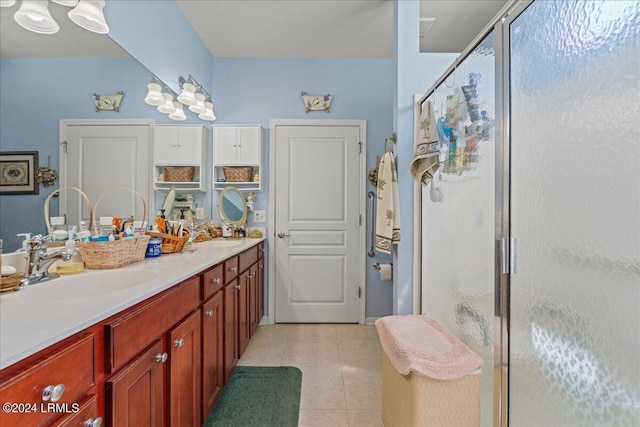 bathroom featuring vanity, tile patterned flooring, and a shower with door