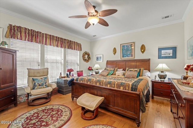 bedroom featuring ornamental molding, ceiling fan, and light wood-type flooring