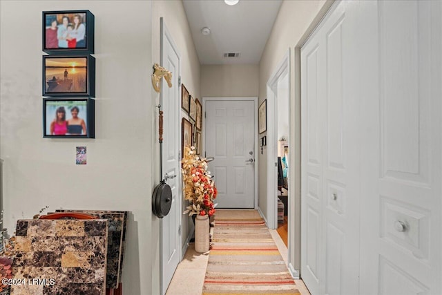 washroom featuring stacked washing maching and dryer and light tile patterned floors