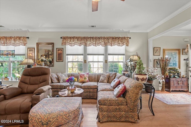 living room featuring light hardwood / wood-style flooring, ornamental molding, and ceiling fan