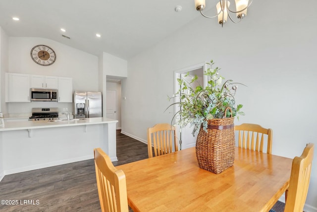 dining space featuring high vaulted ceiling, recessed lighting, a notable chandelier, dark wood-type flooring, and visible vents