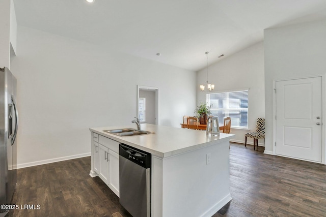 kitchen with a kitchen island with sink, a sink, white cabinetry, hanging light fixtures, and appliances with stainless steel finishes