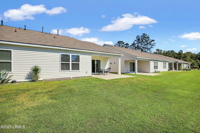 back of property featuring a patio area and a yard