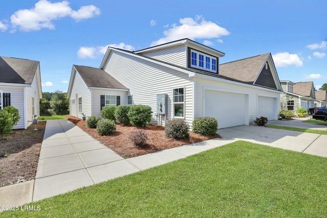 view of side of property with an attached garage, a lawn, and concrete driveway