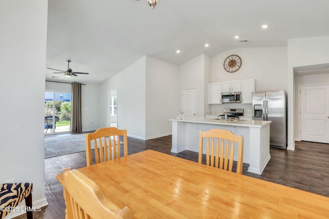 dining space featuring recessed lighting, dark wood-type flooring, a ceiling fan, high vaulted ceiling, and baseboards