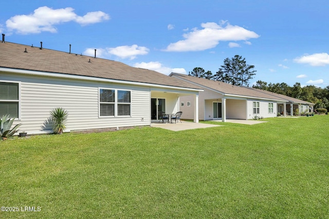 back of house with a yard and a patio area