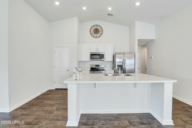 kitchen with stainless steel appliances, light countertops, a sink, and a large island