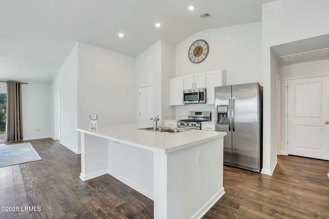 kitchen featuring appliances with stainless steel finishes, a sink, a kitchen island with sink, and white cabinetry