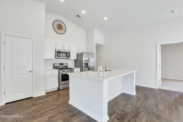 kitchen featuring a kitchen island with sink, visible vents, white cabinetry, light countertops, and appliances with stainless steel finishes