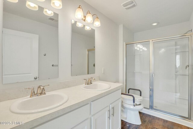 full bathroom with a stall shower, visible vents, a sink, and toilet