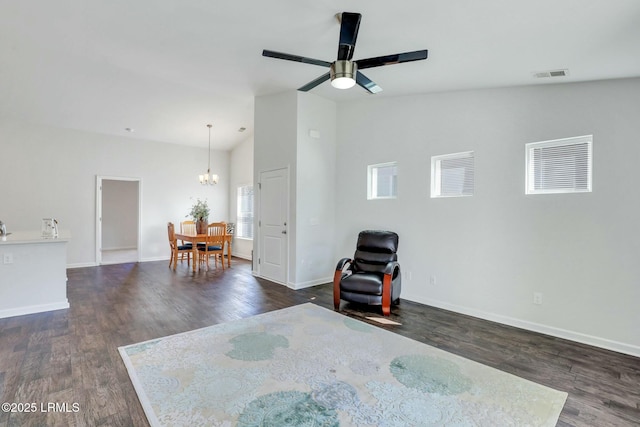 unfurnished room with lofted ceiling, dark wood-style flooring, visible vents, and baseboards