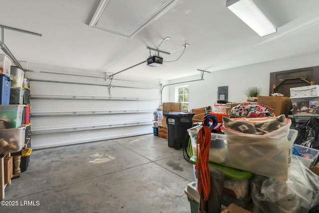 garage featuring electric panel and a garage door opener